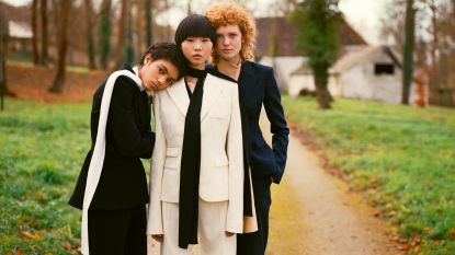 Three women wearing linen suits
