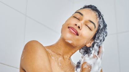 a model washing her hair with a clarifying shampoo